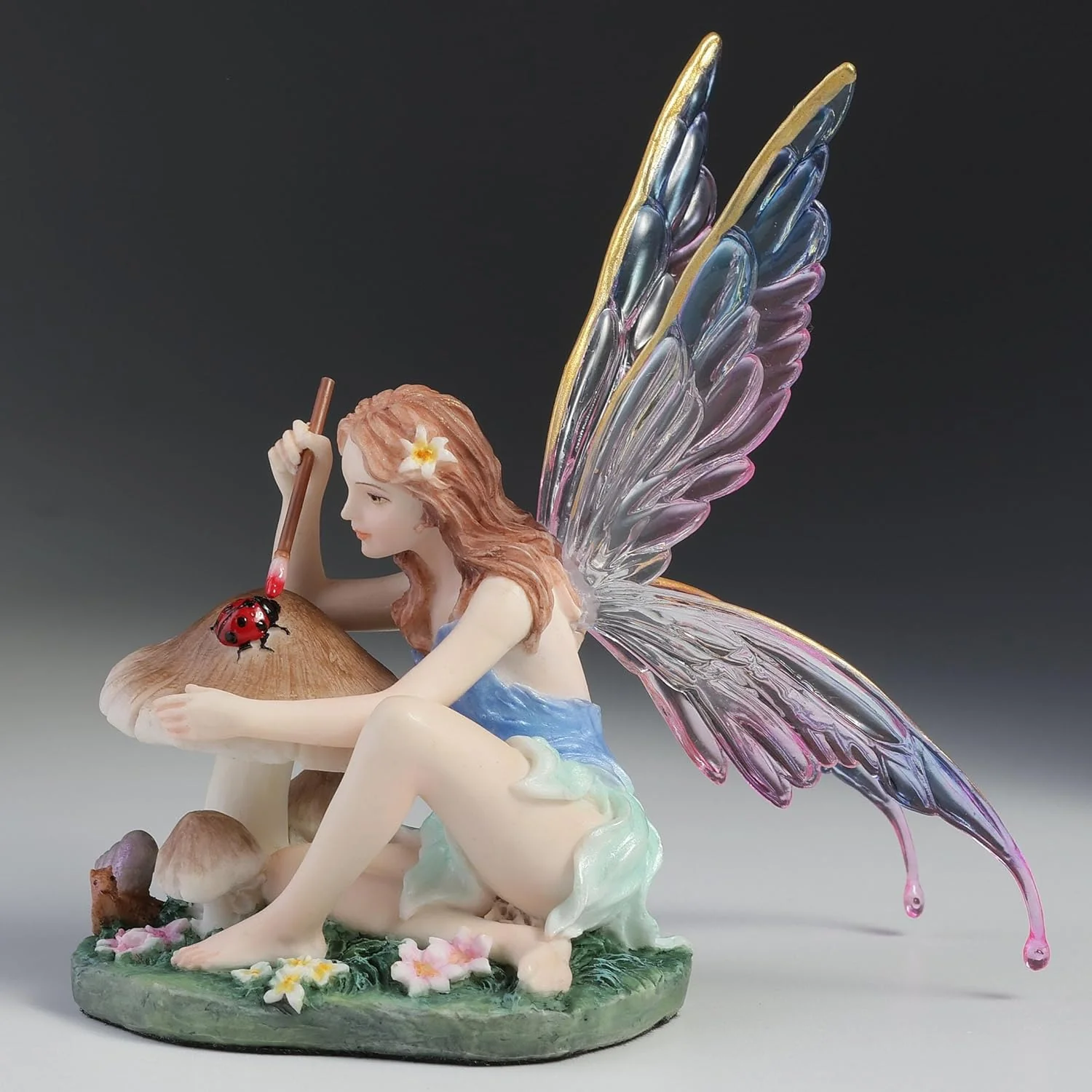 Chromatic Fairy Painting a Lady Bug Figurine - Image 2
