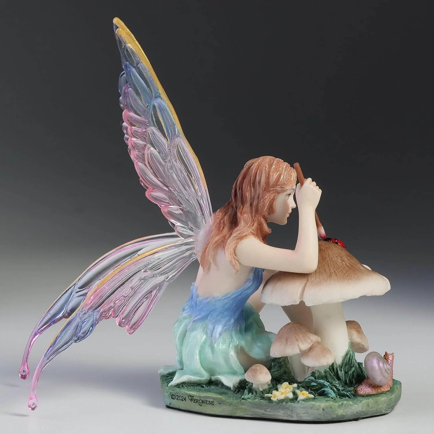 Chromatic Fairy Painting a Lady Bug Figurine - Image 4